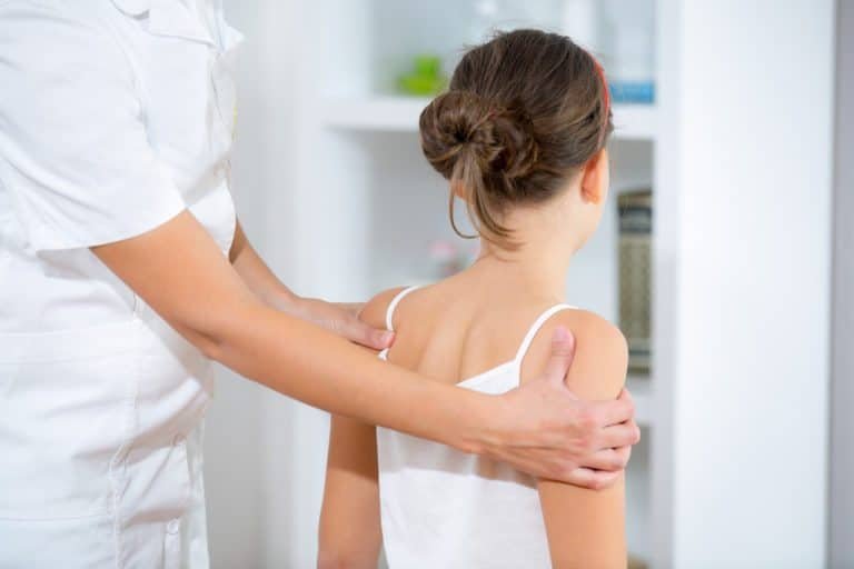 Chiropractor examining a child